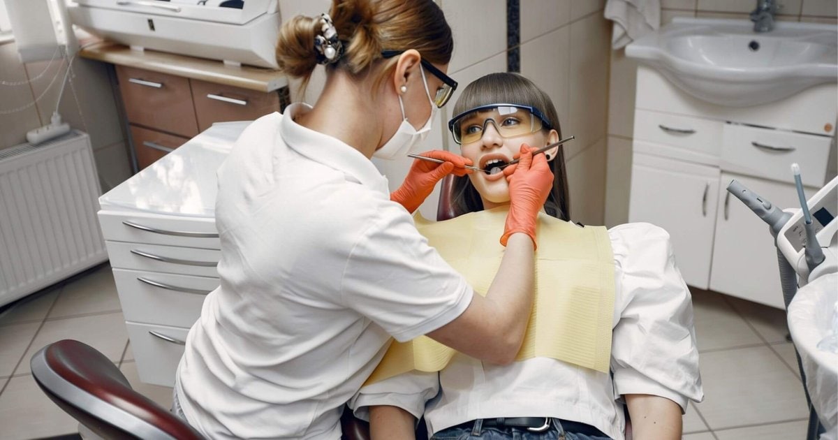 Cheltenham dentist examining a patient's mouth