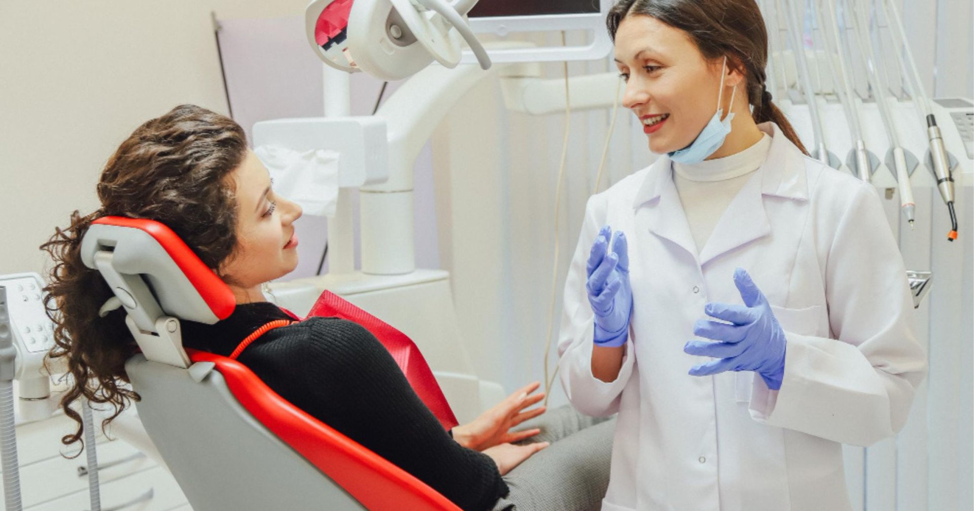 dentist speaking with a patient during a consultation in Cheltenham